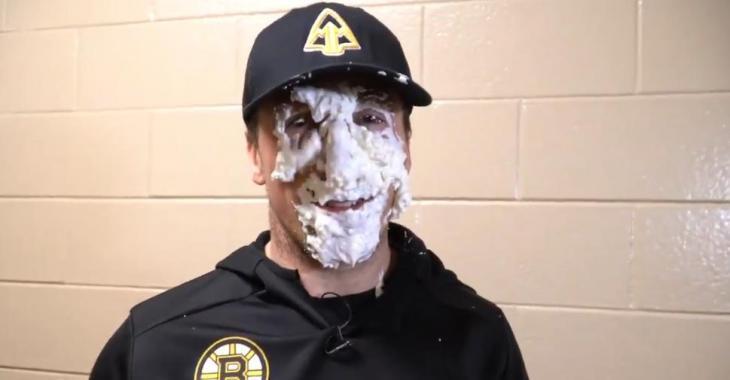 Bruins star Brad Marchand takes a pie to the face.